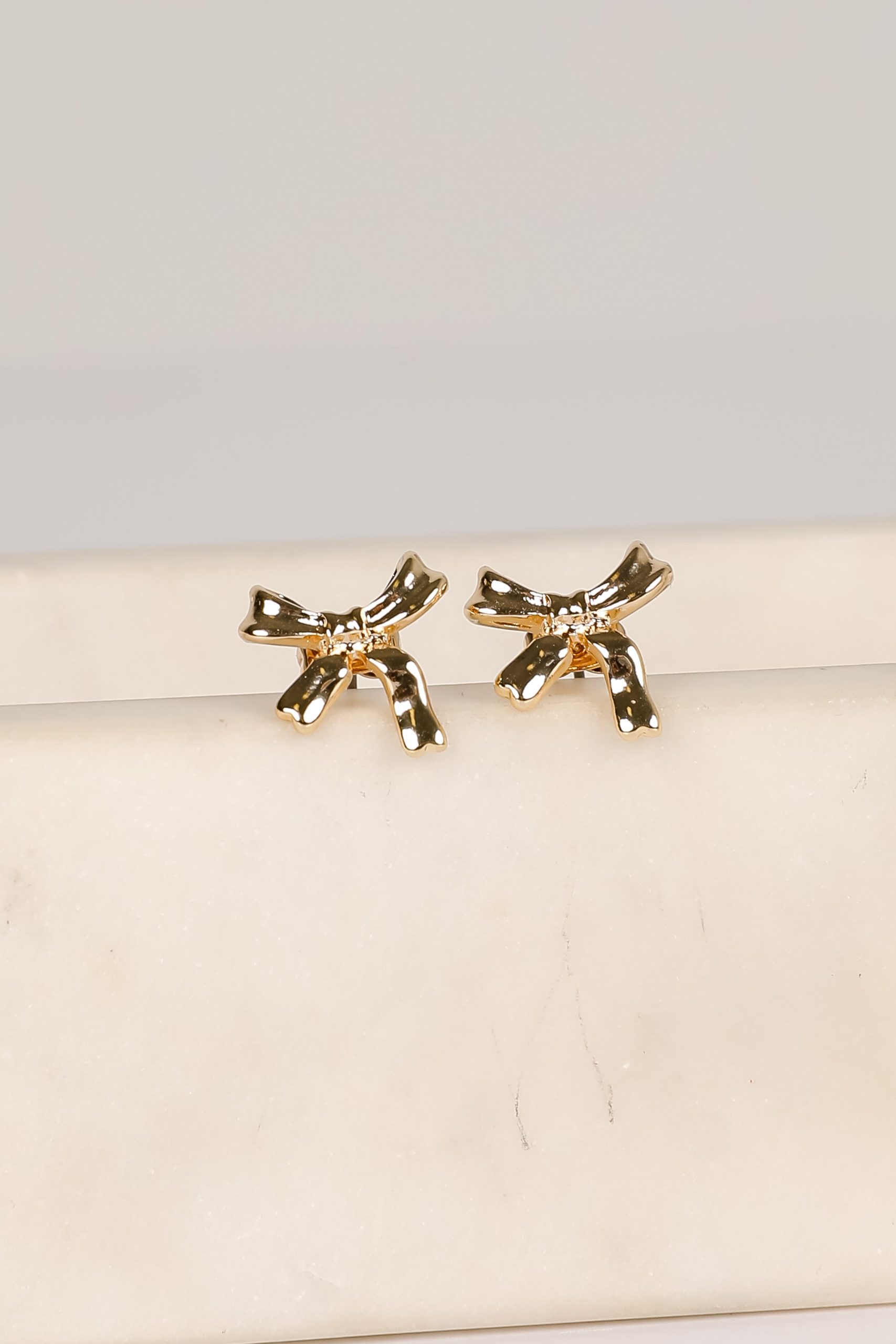 shopdressup_gold_bow_earrings-3_e074f9c6-9085-4e47-a8f7-cfd0e167ccde.jpg