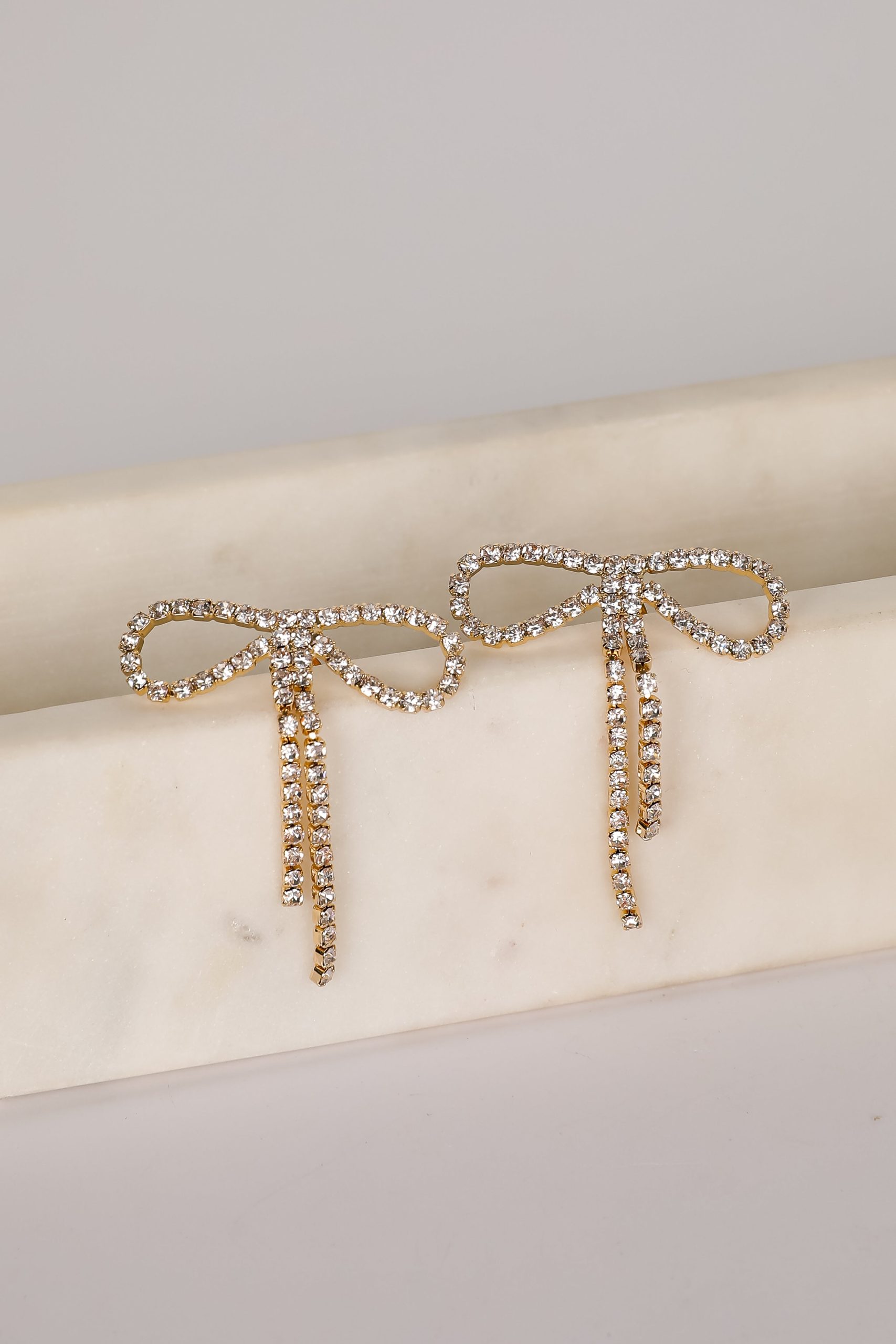shopdressup_gold_rhinestone_bow_earrings_497e3f6d-b756-4a23-84a0-9d013ee18c60.jpg